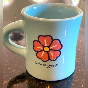 Life Is Good Light Blue Mug with Pink and Yellow Flower Center.  Like new.